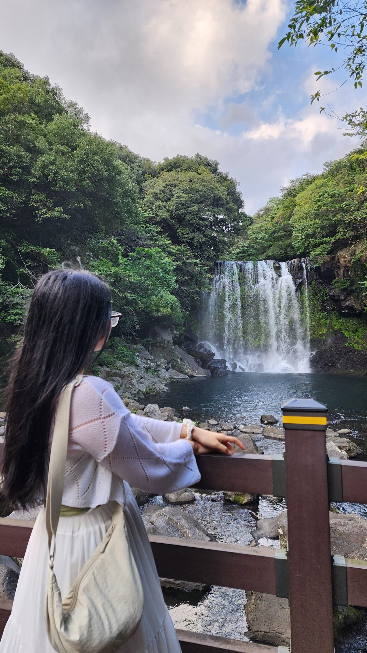 Things to do in Jeju, Cheonjeyeon Waterfall, girl watching waterfall